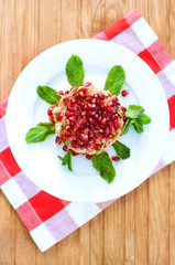 Fresh summer salad with pomegranate, tuna fish, carrots and mint