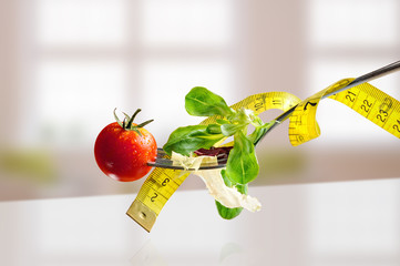 Concept diet fork with salad and metro horizontal composition