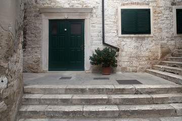 Fototapeta na wymiar Medieval building with green door