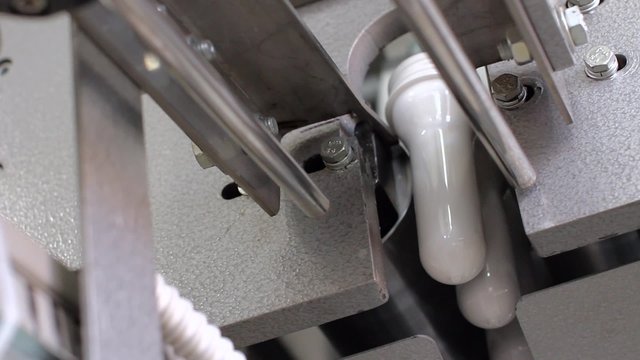 White PET bottle preform on conveyor