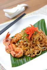Close-up stir fried char kuey teow with chopstick and drink
