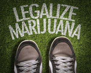 Top View of Sneakers on the grass with the text: Legalize Marijuana