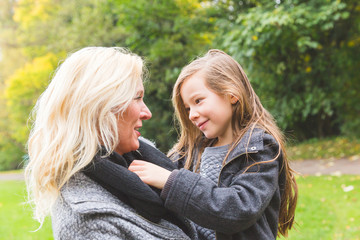 Fototapeta premium Mother and daughter playing and looking each other at park