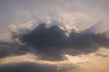 Fototapeta na wymiar Rays of light shining through clouds, sunset