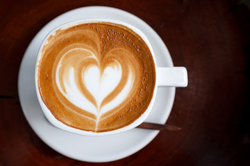 Cup of latte coffee on wooden