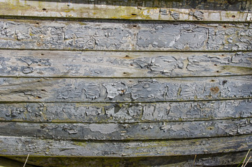 Peeling gray painted wooden siding