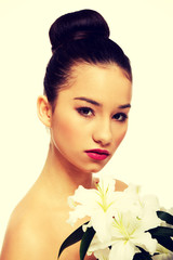 Fototapeta premium Beauty face of a woman with flower.