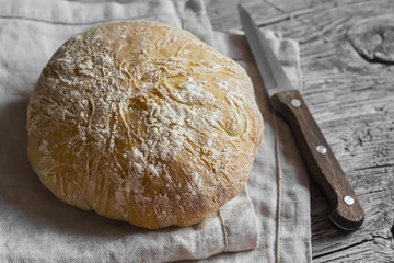 Homemade rustic bread on light wooden board
