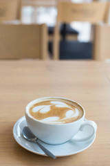 Hot art Latte Coffee in a cup on wooden table