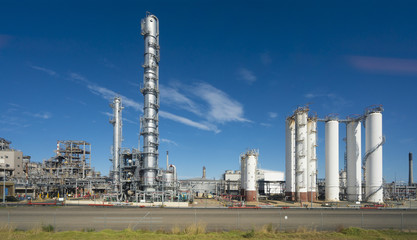 Fototapeta na wymiar Oil refinery against blue sky