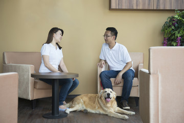asian couple at cafe with their pets