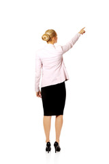 Back view of young business  woman pointing for somathing