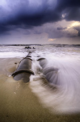 beautiful sunrise sunset at the beach. dramatic clouds. soft focus on the wave and cloud
