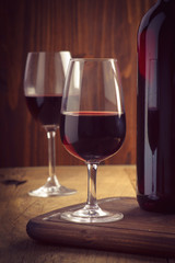 glasses and bottle of wine on old wood