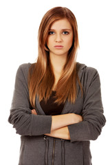 Worried teenage woman with folded arms