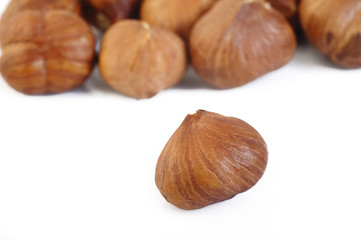 peeled hazelnuts isolated on white
