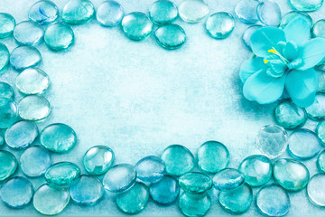 Blue glass drops aqua with flower orchid background