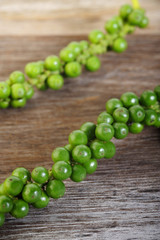 green pepper grain on wooden background