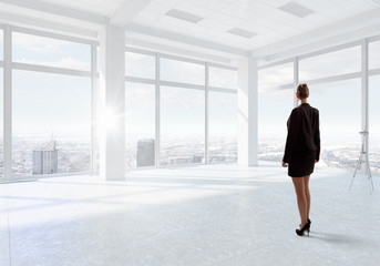 Fototapeta na wymiar Businesswoman in top floor office