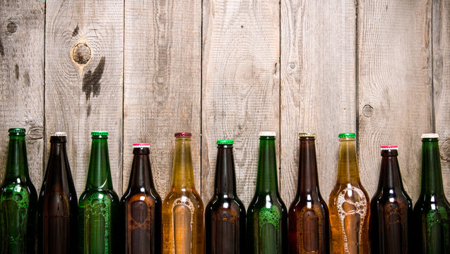 Beer Bottles On Wooden Table .