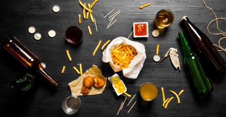 Beer background. Fresh beer and snacks for him on large black table. Beer party.