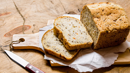 Bread with herbs and knife on Board. © Artem Shadrin