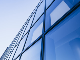 Fototapeta na wymiar Architecture detail Modern Glass facade Background Blue tone