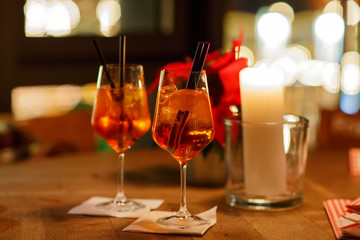 Aperol Spritz Cocktai on table with ice cubes and oranges
