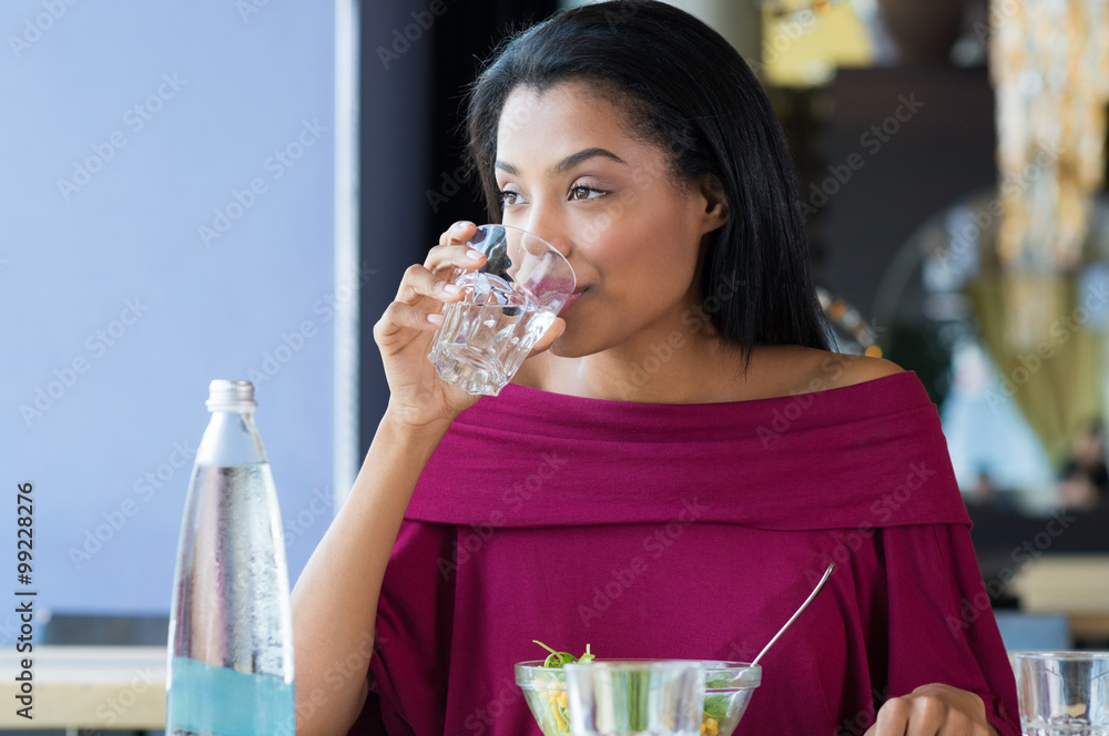 Wall mural young woman drinking water