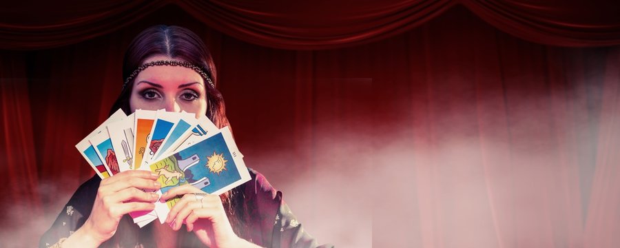 Fortune teller hiding mouth with cards