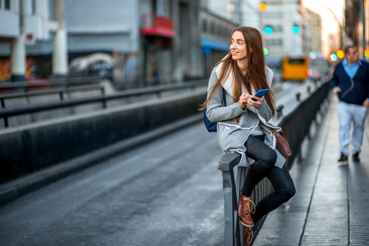 Woman With Phone In The City