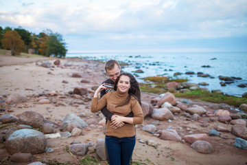 Young couple hugging on a rocky seashore