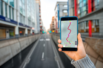 Holding smartphone on the city background