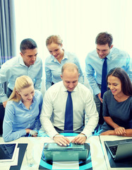 smiling business people with laptop in office