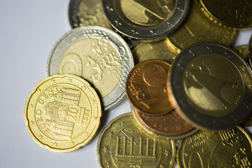 used euro coins with scratches on white background