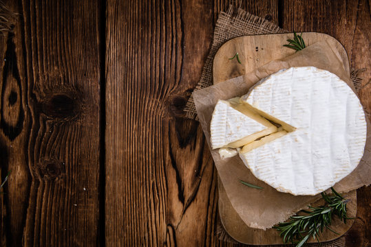 Creamy Camembert on wooden background