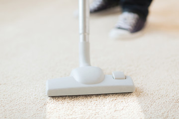 close up of male hoovering carpet