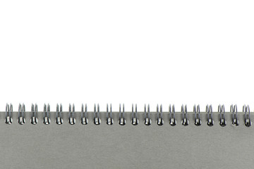 Wire bound or spiral bound sketchbook made from grey board isolated on white background.