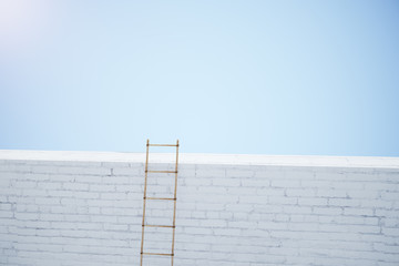 Stairway on white brick wall at blue sky background