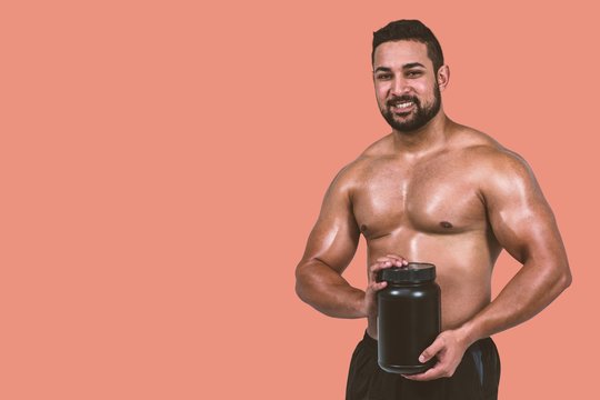 Composite image of muscular man with protein powder