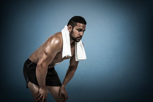 Composite image of muscular man with towel on shoulders