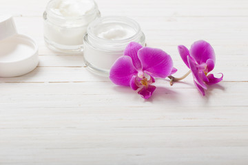 cream and pink orchid flowers on white wooden background