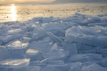 Fototapeta na wymiar Ice of Baikal lake at sunset