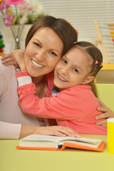 Fototapeta premium Daughter and mother reading the book