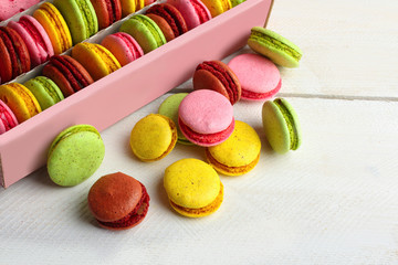 Colourful tasty macaroons in a box on a wooden table