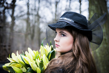 The woman in the black comes to park with flowers
