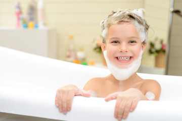 Cute little girl washing her hair 