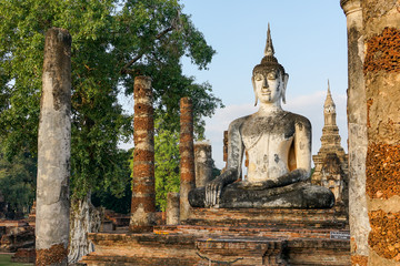Fototapeta na wymiar Buddha Buddhist temple ruins in Sukhothai historical park Wat Mahathat.