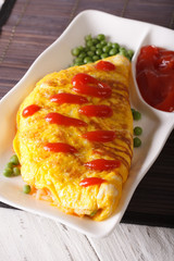 Japanese omelet stuffed with rice and chicken close-up. vertical
