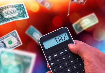 Fototapeta na wymiar Calculator with the word Tax on the display, background with dol